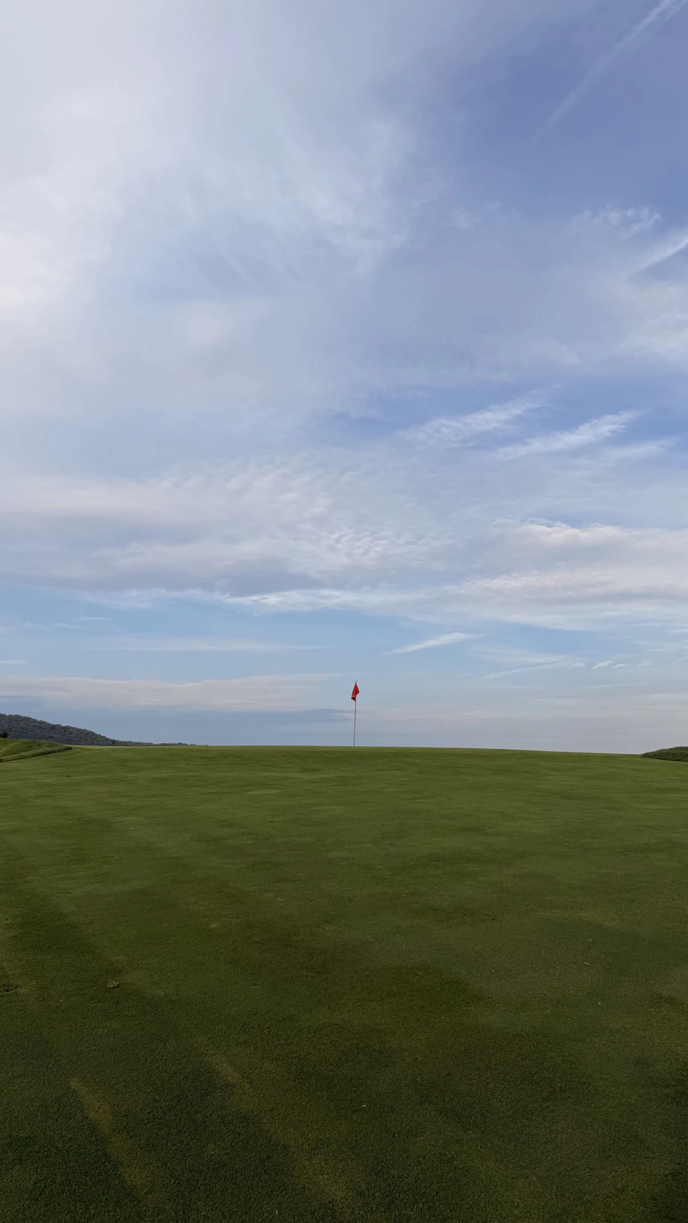 An open green and red flag at Paramount Country Club